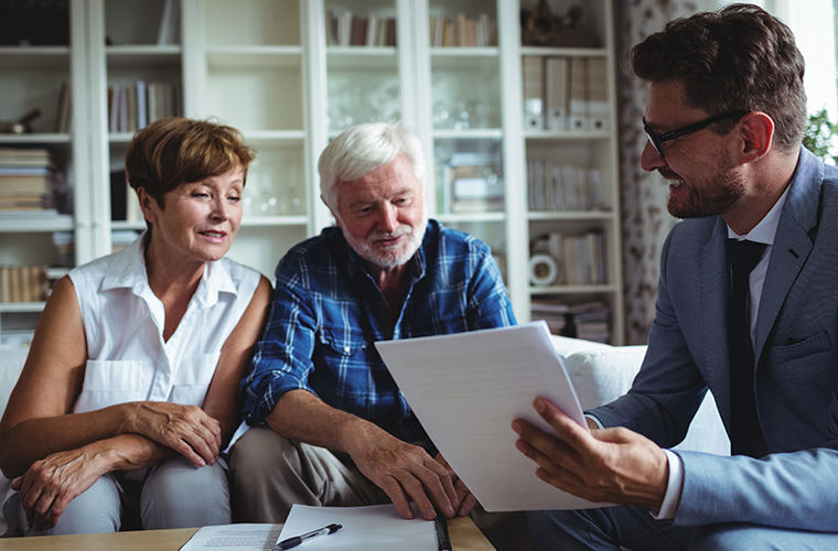Senior couple planning their investments with financial advisor
