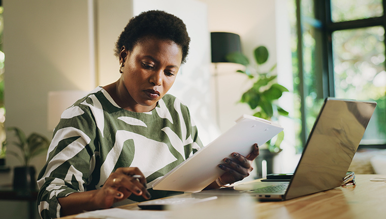 Finance, documents and black woman with calculator in home for budget planning, taxes and rebate.